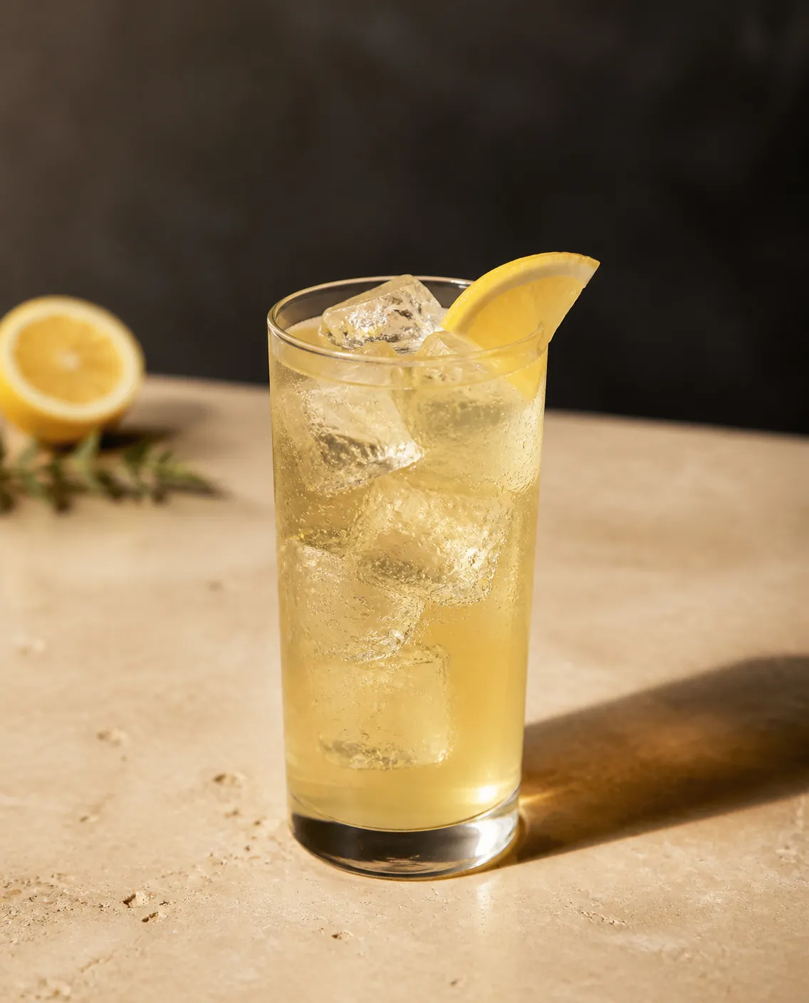 Apple Whiskey Lemonade in a highball glass with lemonade or lemon-lime soda, to top and lemon wedge (AI-generated image)