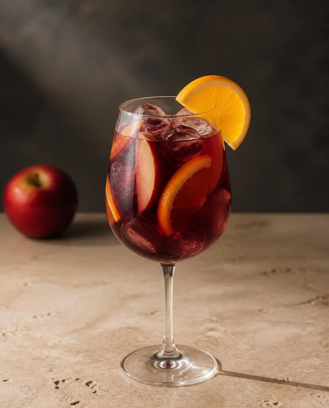 Fall Sangria in a wine glass with orange slice and apple slice (AI-generated image)